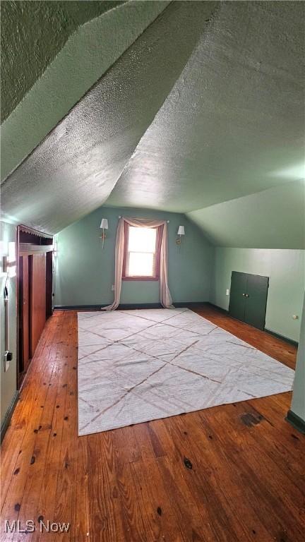 25801 Zeman Ave, Euclid, OH 44132 - additional living space with hardwood / wood-style flooring, a textured ceiling, and lofted ceiling