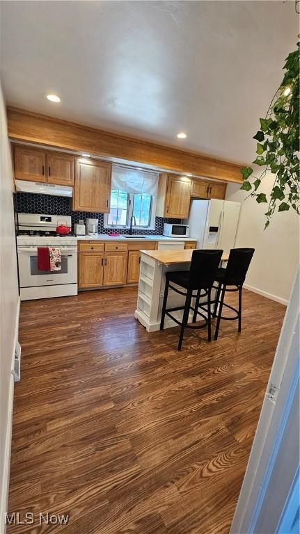 25801 Zeman Ave, Euclid, OH 44132 - kitchen with white appliances, under cabinet range hood, light countertops, dark wood-type flooring, and recessed lighting