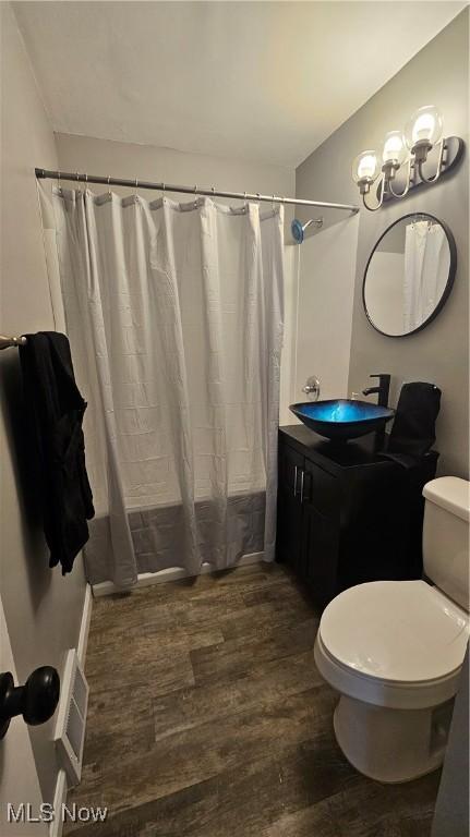 25801 Zeman Ave, Euclid, OH 44132 - bathroom with wood finished floors, vanity, and shower / tub combo