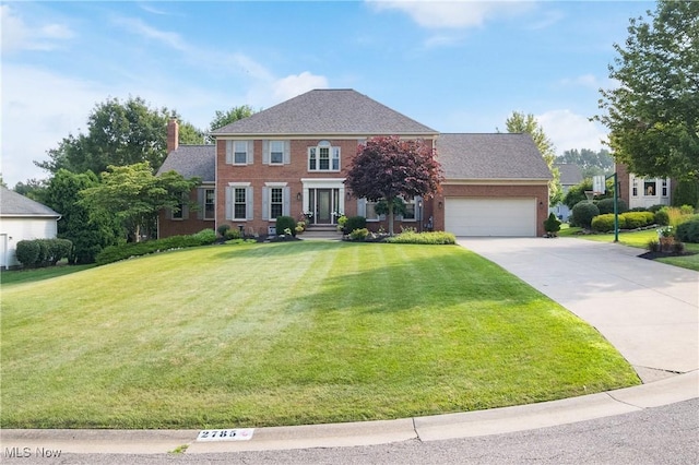 2785 Chalford Cir NW, North Canton, OH 44720 - colonial inspired home with brick siding, a chimney, a front lawn, concrete driveway, and a garage