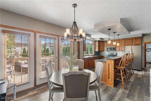 2785 Chalford Cir NW, North Canton, OH 44720 - dining area with dark wood-type flooring, a textured ceiling, and a chandelier