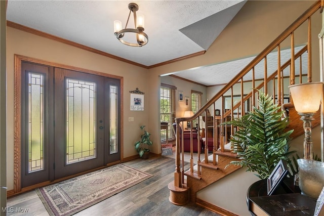 2785 Chalford Cir NW, North Canton, OH 44720 - entryway featuring wood finished floors, stairs, a chandelier, crown molding, and a textured ceiling