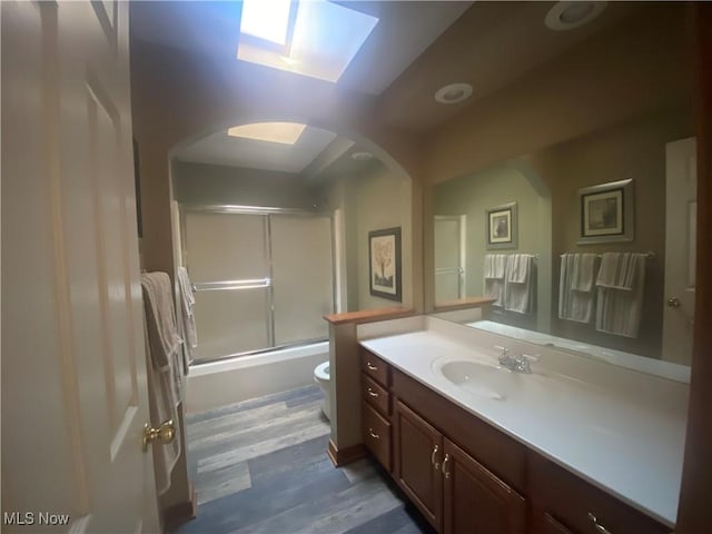 2785 Chalford Cir NW, North Canton, OH 44720 - bathroom with vanity, wood finished floors, and combined bath / shower with glass door