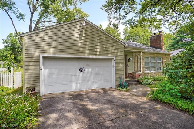 593 Mardon Ave, Akron, OH 44303 - view of front of home featuring a chimney, a garage, and driveway