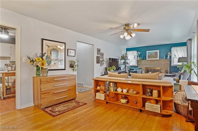 593 Mardon Ave, Akron, OH 44303 - living area featuring ceiling fan, light wood-style flooring, and a fireplace