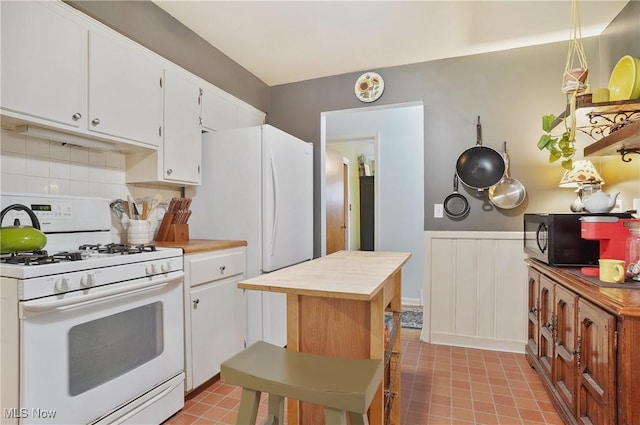593 Mardon Ave, Akron, OH 44303 - kitchen with white appliances, wooden counters, white cabinets, a wainscoted wall, and a decorative wall