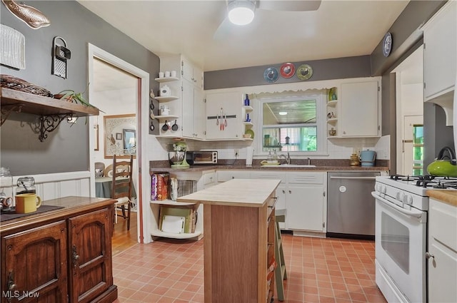 593 Mardon Ave, Akron, OH 44303 - kitchen featuring open shelves, stainless steel dishwasher, white gas range, a ceiling fan, and decorative backsplash