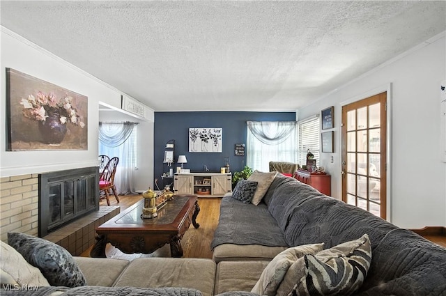 4221 2nd St NW, Canton, OH 44708 - living room with a textured ceiling, wood finished floors, crown molding, and a brick fireplace