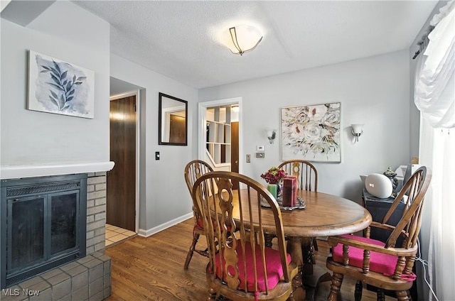 4221 2nd St NW, Canton, OH 44708 - dining space with a brick fireplace and wood finished floors
