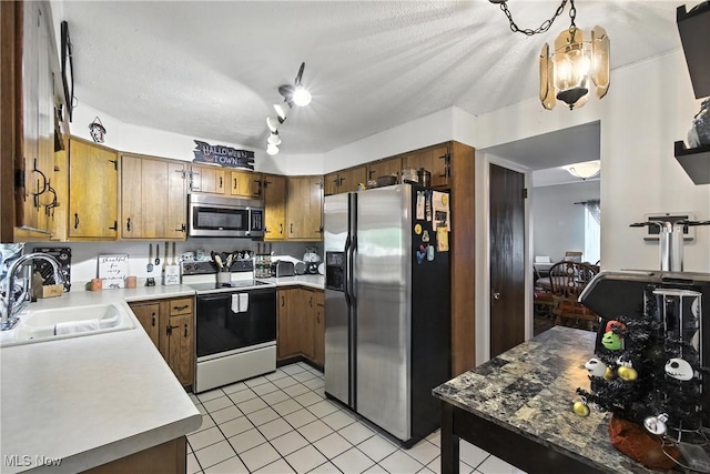4221 2nd St NW, Canton, OH 44708 - kitchen featuring stainless steel appliances, light tile patterned flooring, light countertops, and brown cabinetry