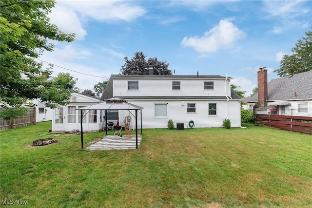4221 2nd St NW, Canton, OH 44708 - back of property with a gazebo, a patio area, a chimney, and an outdoor fire pit
