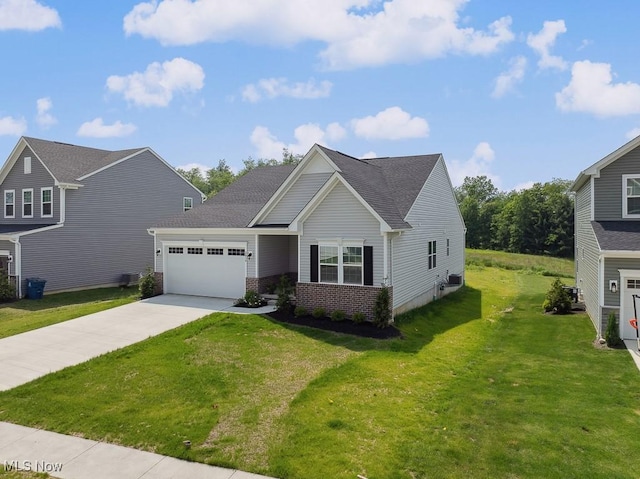 2014 Sugar Maple Dr, Kent, OH 44240 - view of front of house with a garage, concrete driveway, a front yard, brick siding, and a shingled roof