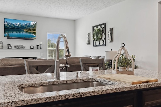 2014 Sugar Maple Dr, Kent, OH 44240 - kitchen featuring open floor plan, light stone counters, and a textured ceiling