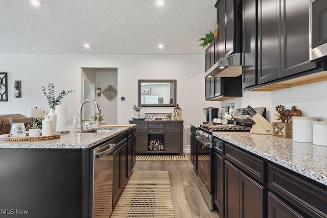 2014 Sugar Maple Dr, Kent, OH 44240 - kitchen with appliances with stainless steel finishes, wood finished floors, ventilation hood, light stone countertops, and a textured ceiling