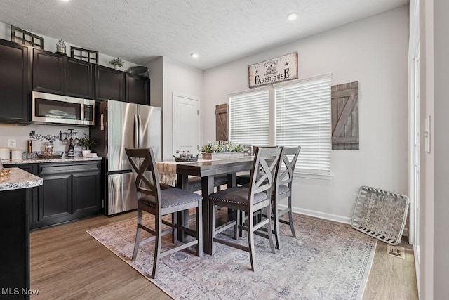 2014 Sugar Maple Dr, Kent, OH 44240 - dining area featuring light wood-style floors, recessed lighting, and a textured ceiling