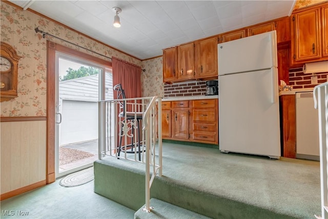 409 Yager Rd, New Franklin, OH 44216 - kitchen with freestanding refrigerator, wallpapered walls, brown cabinets, light countertops, and crown molding