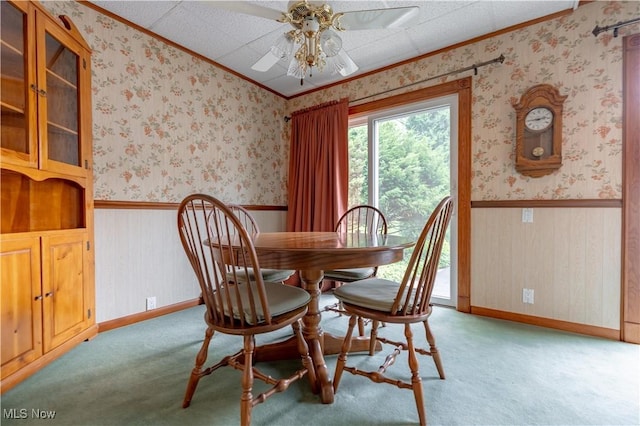 409 Yager Rd, New Franklin, OH 44216 - carpeted dining area featuring ornamental molding, a wainscoted wall, a ceiling fan, and wallpapered walls
