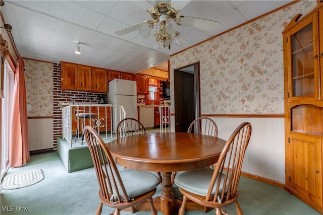 409 Yager Rd, New Franklin, OH 44216 - dining area with wallpapered walls, a ceiling fan, light colored carpet, wainscoting, and ornamental molding