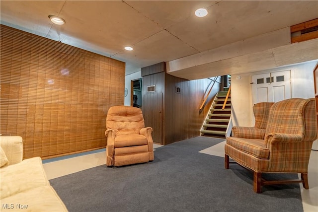 409 Yager Rd, New Franklin, OH 44216 - living room with wood walls, stairway, and carpet floors