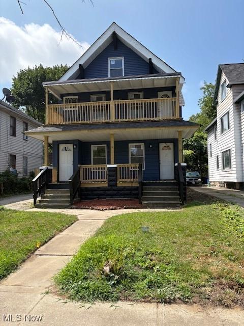 10410 Adams Ave, Cleveland, OH 44108 - view of front of property featuring covered porch, a balcony, and a front lawn