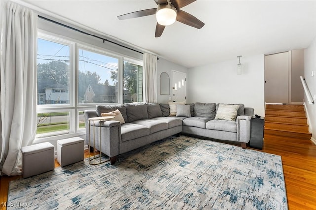 1103 Clinton Ave SE, North Canton, OH 44720 - living room featuring wood finished floors, a ceiling fan, and stairway
