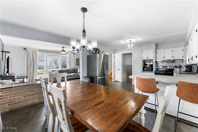 1103 Clinton Ave SE, North Canton, OH 44720 - dining area with a chandelier and a ceiling fan