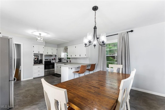1103 Clinton Ave SE, North Canton, OH 44720 - dining area featuring a chandelier and baseboards