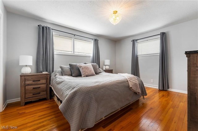 1103 Clinton Ave SE, North Canton, OH 44720 - bedroom featuring multiple windows and hardwood / wood-style floors