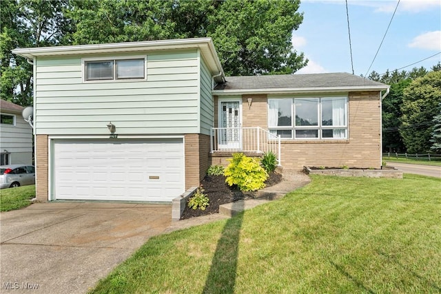 1103 Clinton Ave SE, North Canton, OH 44720 - tri-level home with brick siding, a garage, a front yard, and driveway