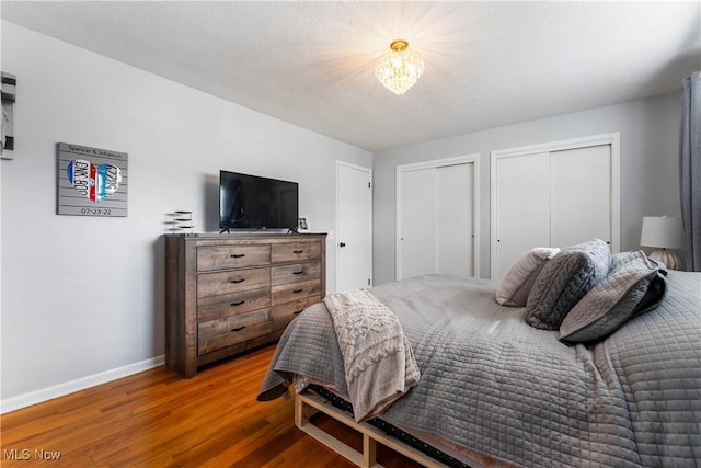 1103 Clinton Ave SE, North Canton, OH 44720 - bedroom featuring two closets and wood finished floors