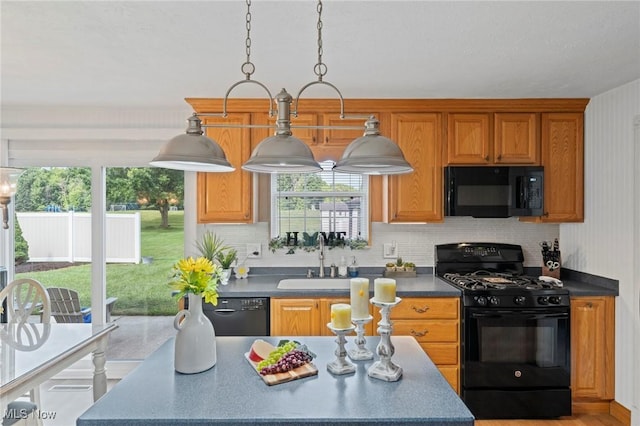 136 Westchester Dr, Brunswick, OH 44212 - kitchen featuring black appliances, dark countertops, plenty of natural light, and brown cabinetry