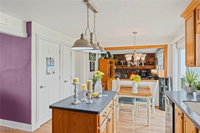 136 Westchester Dr, Brunswick, OH 44212 - kitchen with dishwasher, dark countertops, light wood-type flooring, a chandelier, and hanging light fixtures