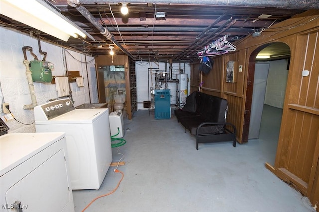 1299 Herberich Ave, Akron, OH 44301 - unfinished below grade area with washing machine and clothes dryer, a heating unit, arched walkways, and water heater