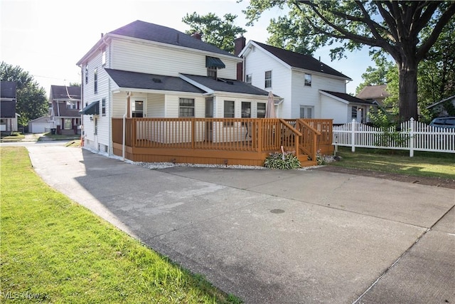 1299 Herberich Ave, Akron, OH 44301 - view of front facade featuring a deck, a chimney, and driveway