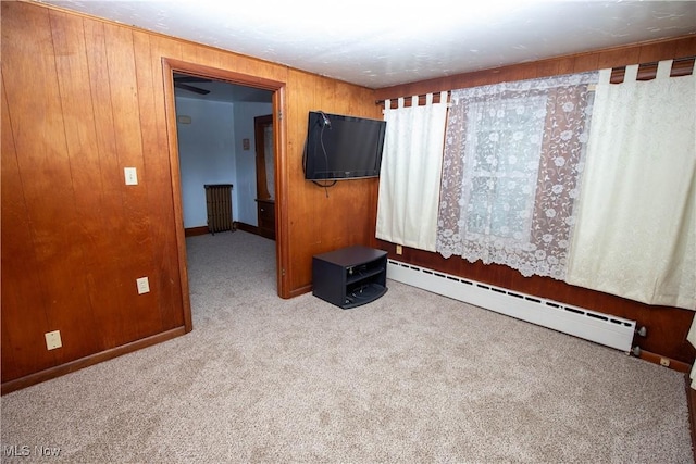 1299 Herberich Ave, Akron, OH 44301 - carpeted spare room featuring a baseboard radiator and wood walls