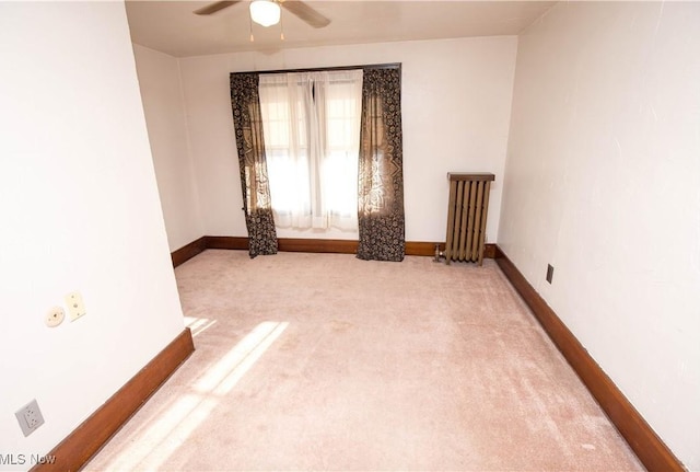 1299 Herberich Ave, Akron, OH 44301 - carpeted spare room with ceiling fan and radiator heating unit