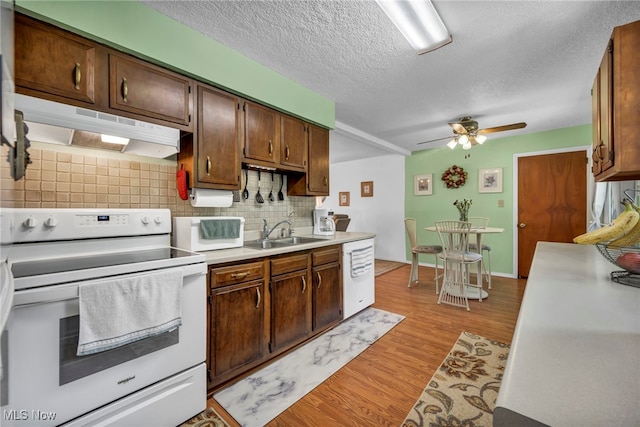 2061 Garden Ln, Hudson, OH 44236 - kitchen featuring white appliances, under cabinet range hood, ceiling fan, backsplash, and light wood-style flooring