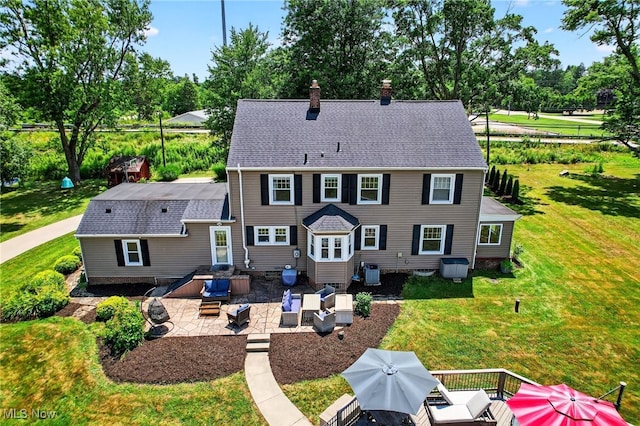 3905 Greenwich Rd, Norton, OH 44203 - back of house featuring a chimney, a patio area, a yard, and view of wooded area