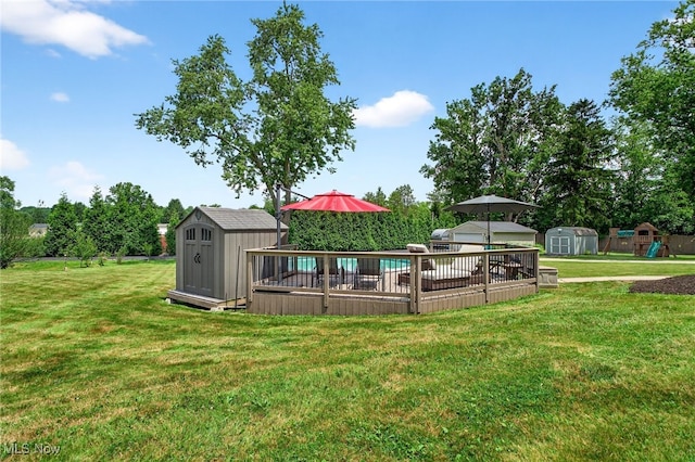 3905 Greenwich Rd, Norton, OH 44203 - view of grassy yard featuring a storage unit, a deck, and a playground