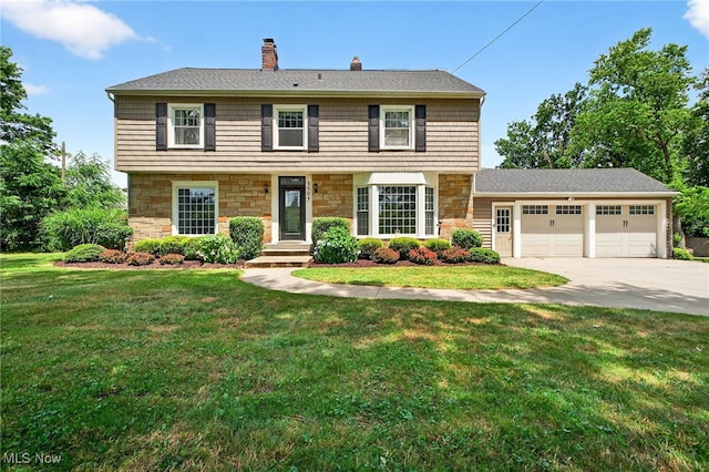 3905 Greenwich Rd, Norton, OH 44203 - colonial-style house with stone siding, a chimney, driveway, a front yard, and an attached garage