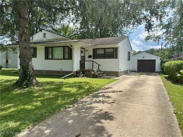 1345 Autumn Dr NW, Warren, OH 44485 - view of front of home with driveway, an outbuilding, a garage, and a front lawn