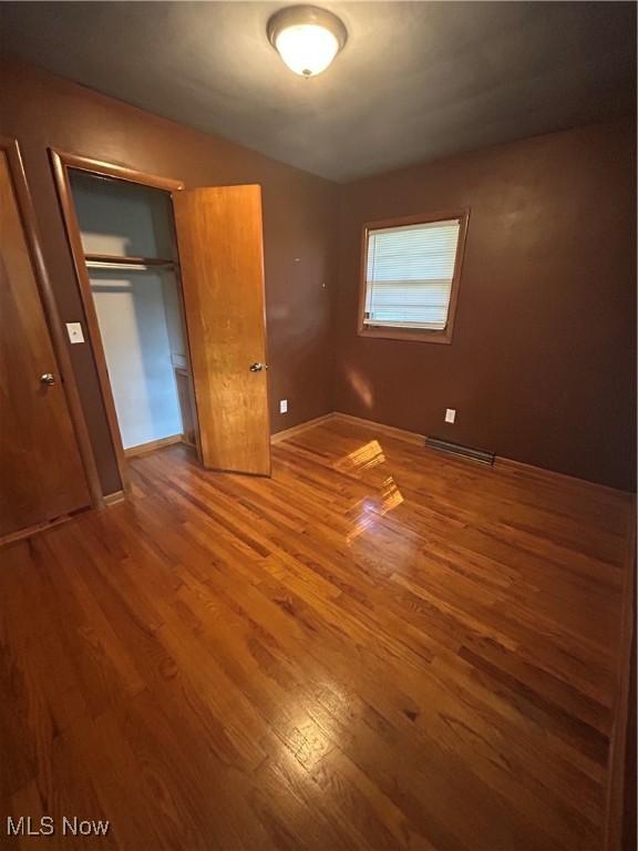 1345 Autumn Dr NW, Warren, OH 44485 - unfurnished bedroom featuring wood finished floors and a closet