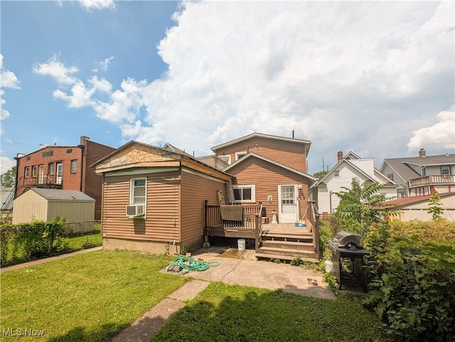 612 W Osborne St, Sandusky, OH 44870 - rear view of house with a wooden deck, a yard, an outbuilding, and cooling unit