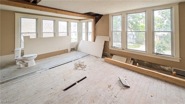 612 W Osborne St, Sandusky, OH 44870 - unfurnished living room with plenty of natural light, a textured ceiling, and hardwood / wood-style floors