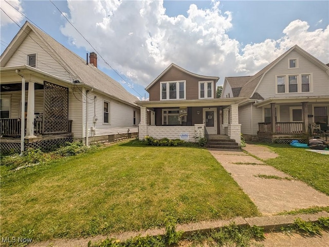 612 W Osborne St, Sandusky, OH 44870 - view of front facade with covered porch and a front lawn