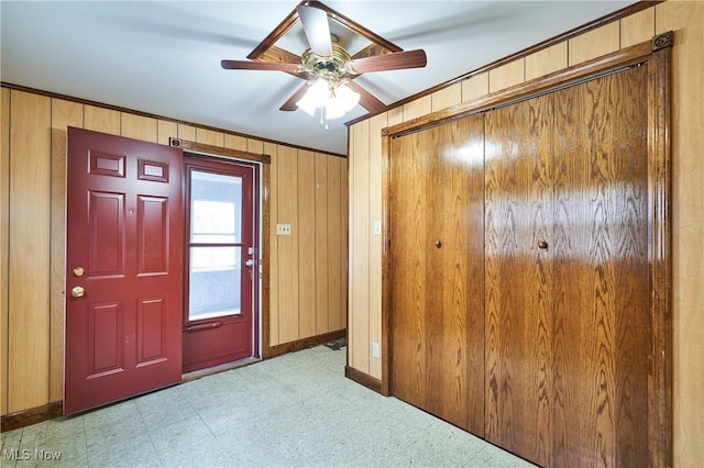 1021 Perry Ave, Barberton, OH 44203 - foyer entrance with tile patterned floors, wooden walls, and a ceiling fan