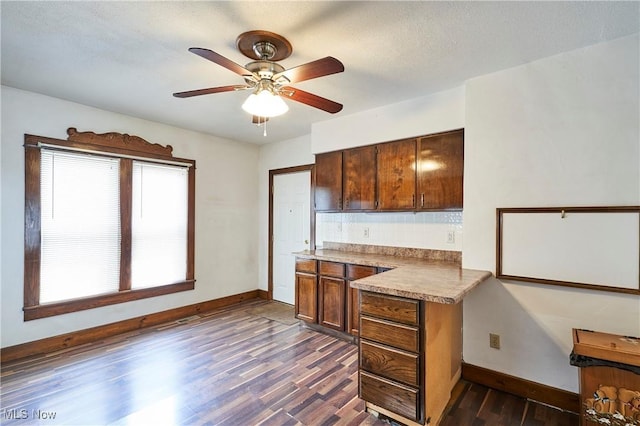 1021 Perry Ave, Barberton, OH 44203 - kitchen featuring dark wood finished floors, a ceiling fan, and tasteful backsplash
