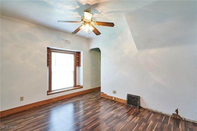 1021 Perry Ave, Barberton, OH 44203 - unfurnished room featuring arched walkways, wood finished floors, and ceiling fan