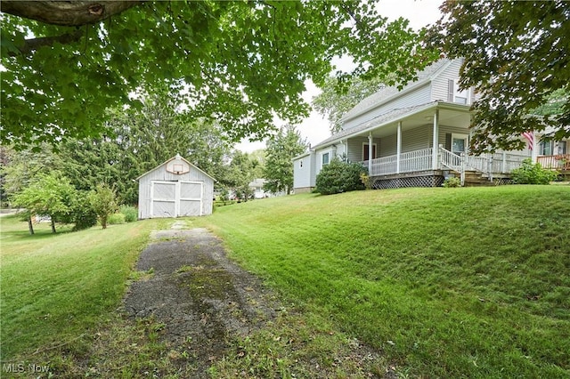 1021 Perry Ave, Barberton, OH 44203 - view of grassy yard featuring a shed and a porch