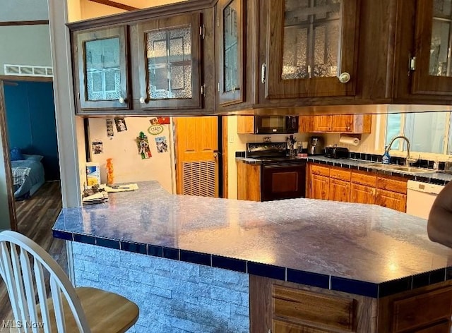 1711 Hardins Run Rd, New Cumberland, WV 26047 - kitchen with black appliances, glass insert cabinets, a peninsula, and dark countertops